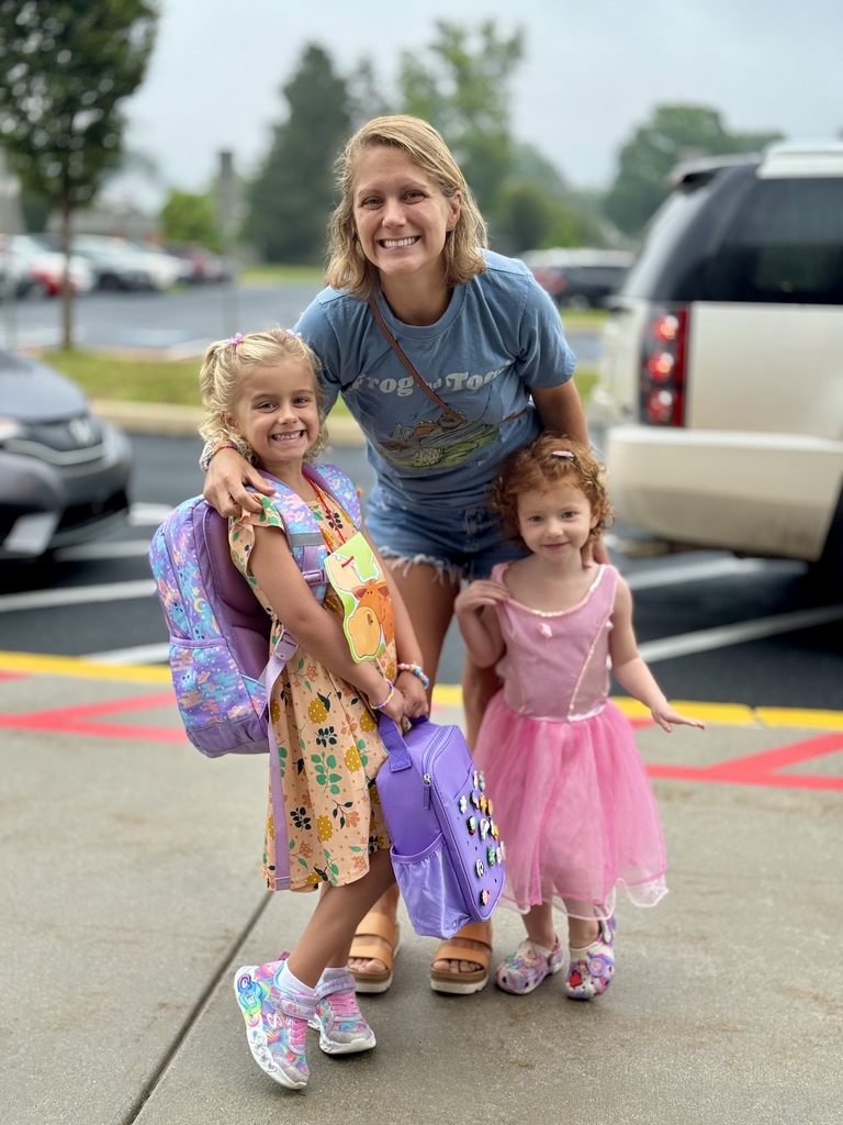 Proud mom with her two girls on the first day of school