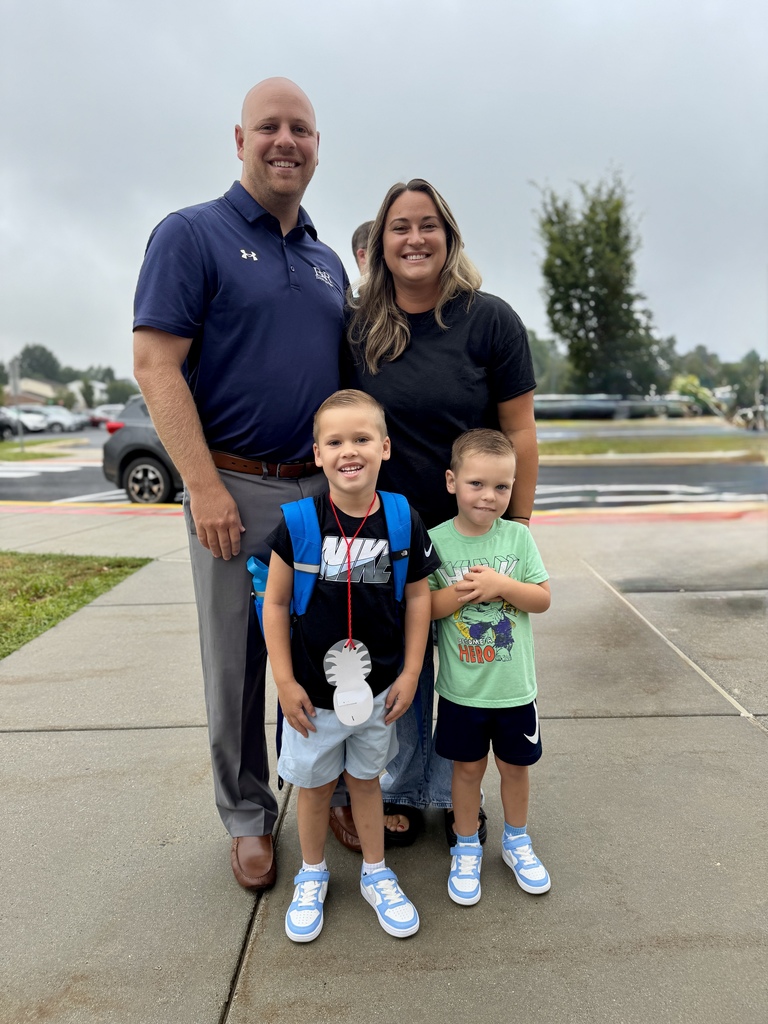 Proud parents with boys on first day of school.