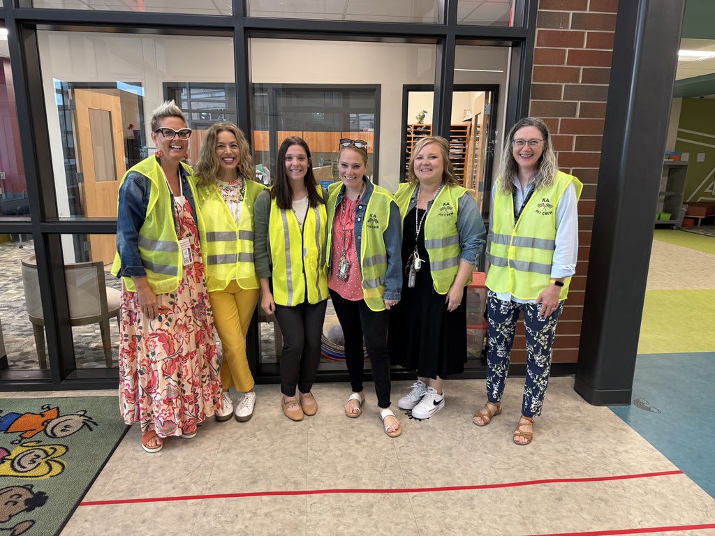 Group of teachers wearing yellow Pit Crew vests