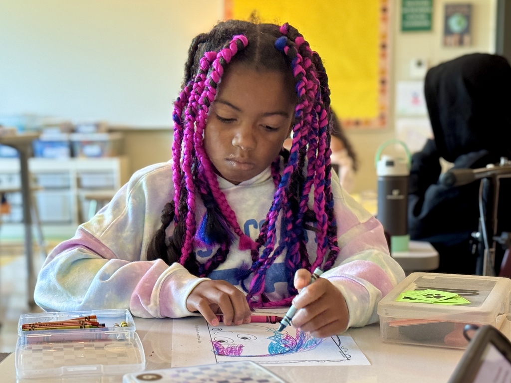Student coloring at desk
