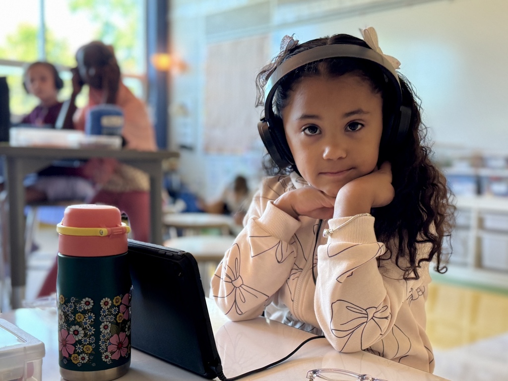 Student sitting at desk with headphones