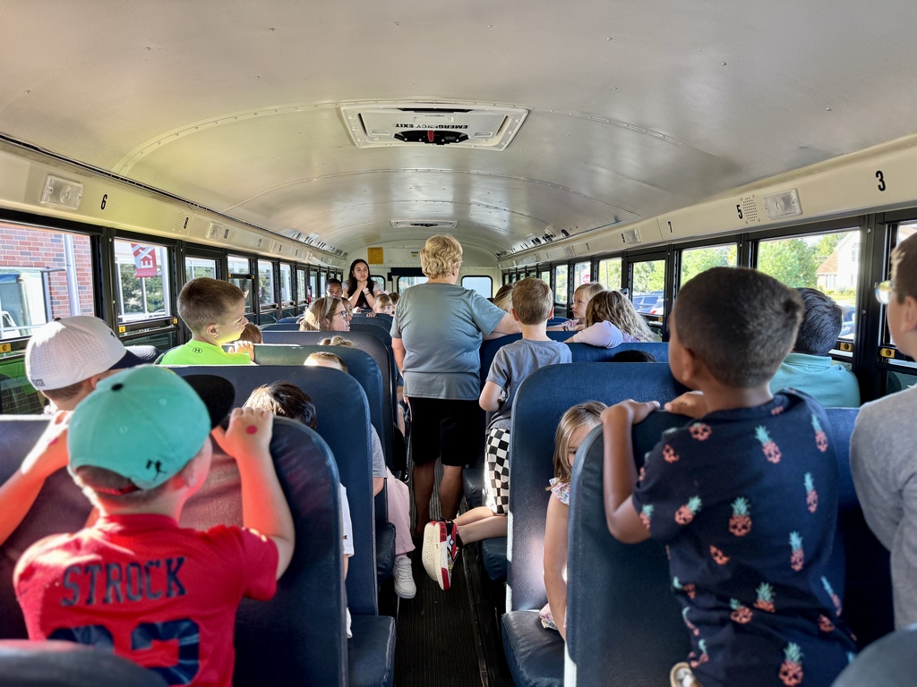Bus driver talks to bus of students