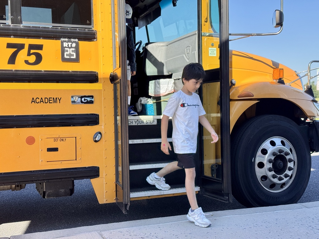 Student exiting yellow school bus