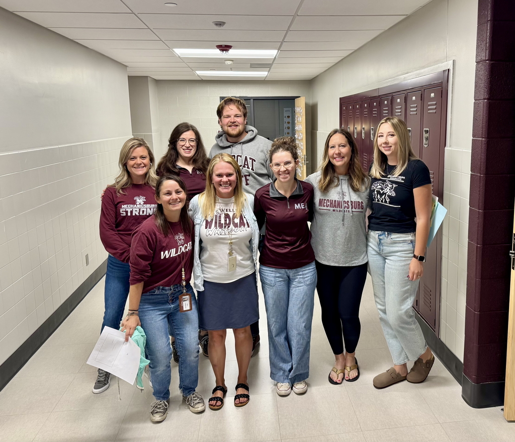 Group of teachers wearing maroon and grey for a spirit day.
