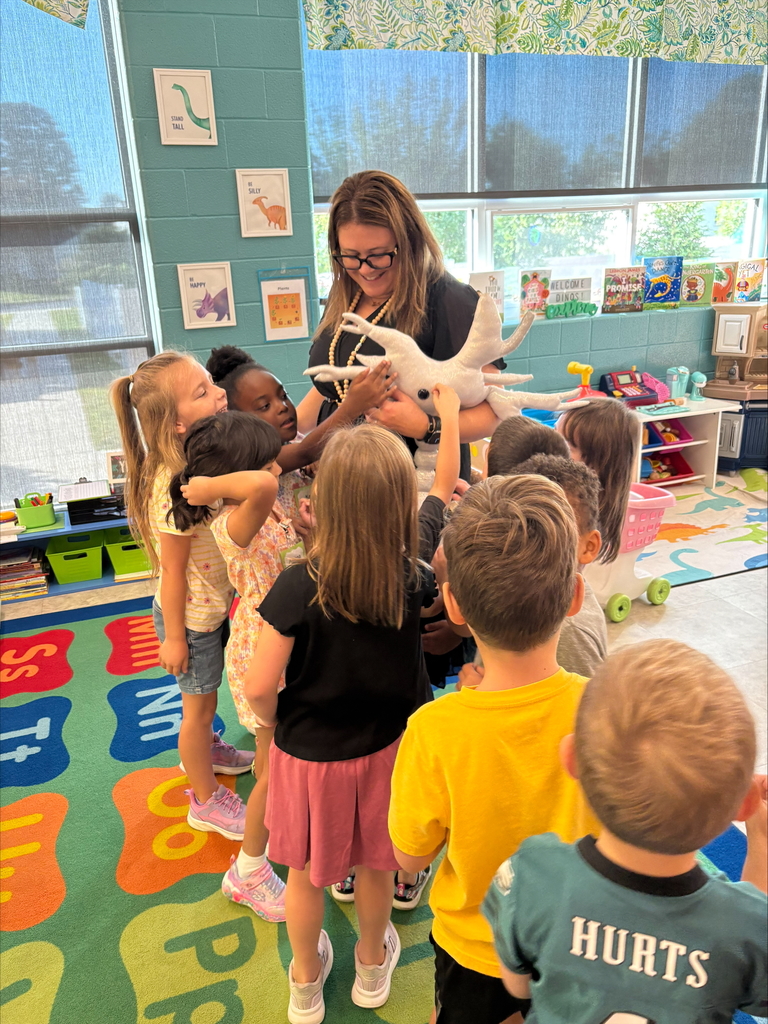 Students touching sparky, a stuffed animal