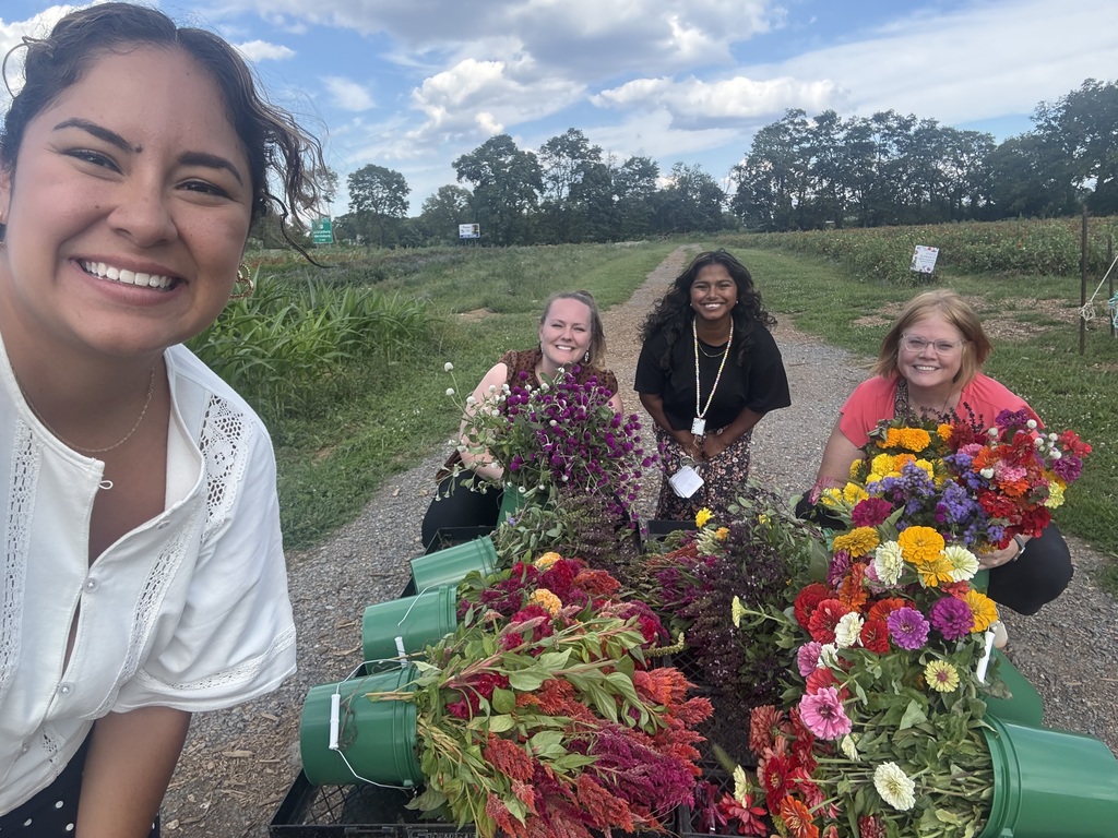 Teachers pulling a wagon of flowers