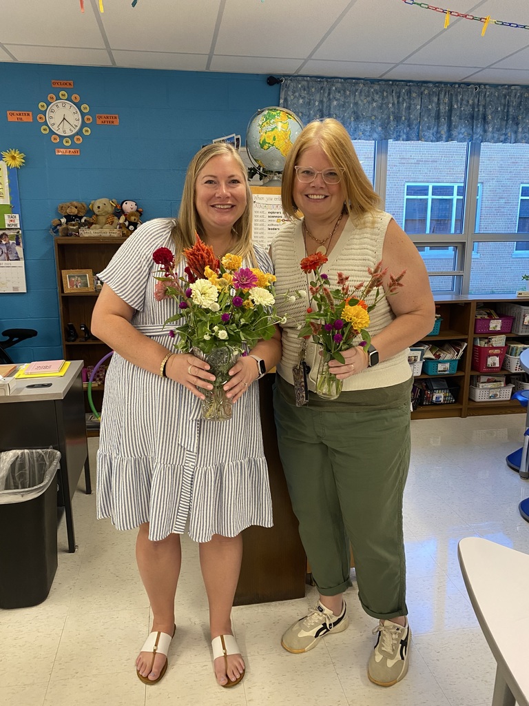 Teachers holding colorful flower bouquets
