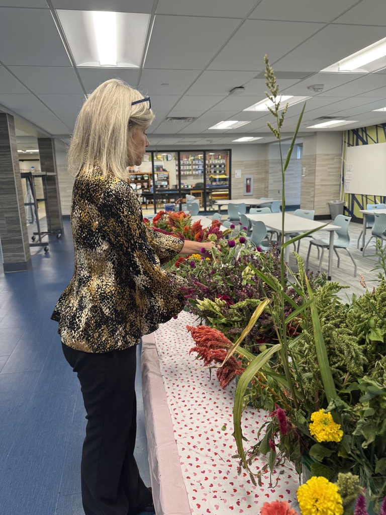 A teacher making a bouqet of flowers