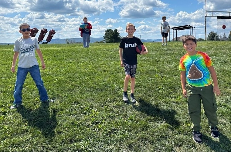 Boys in the grass playing sports