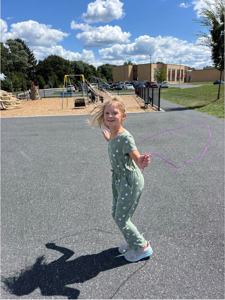A girls playing jump rope at recess