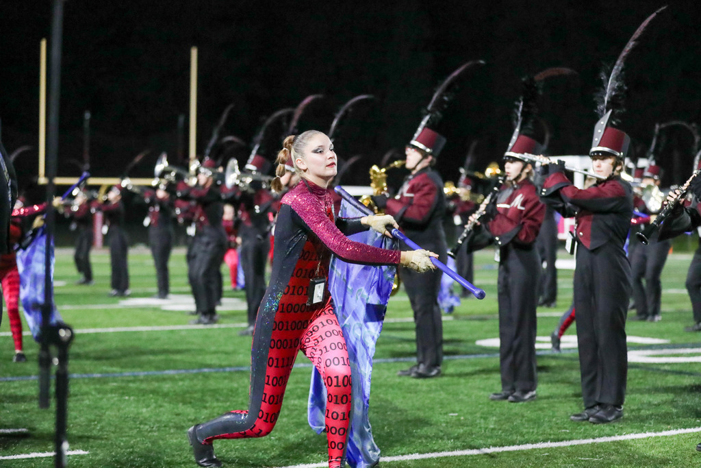 A high school marching band performing during a football game.