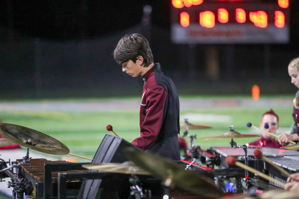 A high school marching band performing during a football game.
