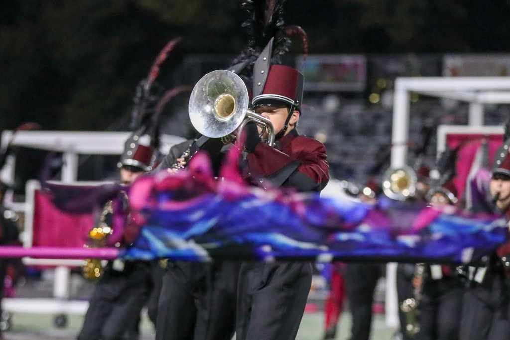 A high school marching band performing during a football game.
