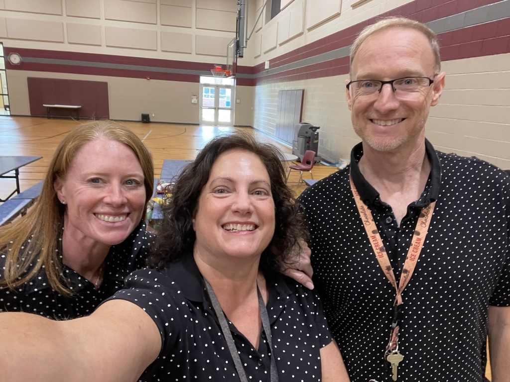 Staff showing off polka dot shirts.