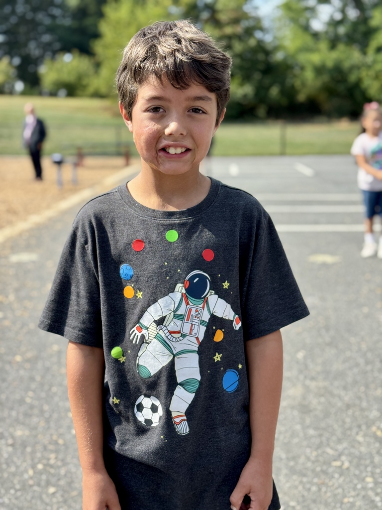 Student showing off homemade dot-themed shirt