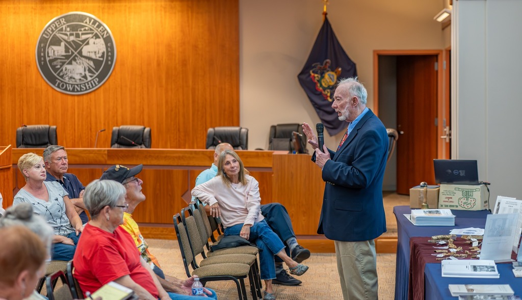 Gentleman speaking in front of a crowd of seated guests