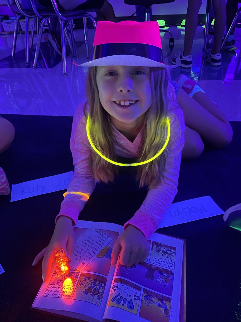 Student wearing glow in the dark hat and necklace