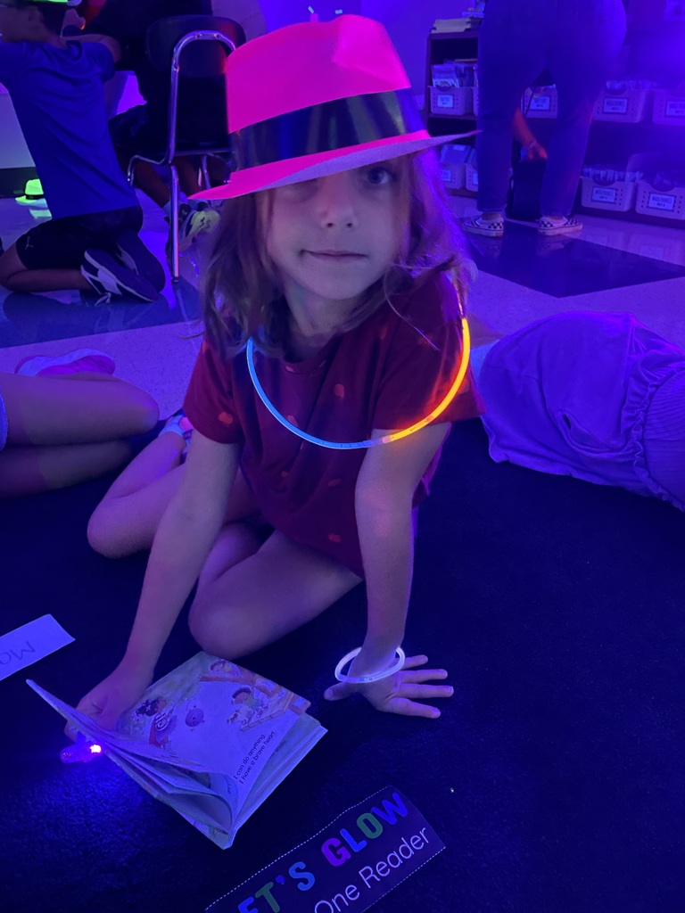 Student wearing glow in the dark hat and necklace