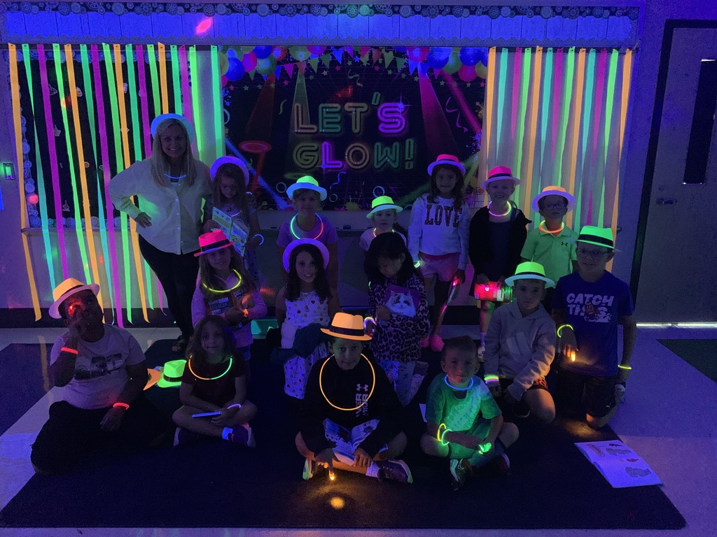 Group of students wearing glow in the dark hats and necklaces