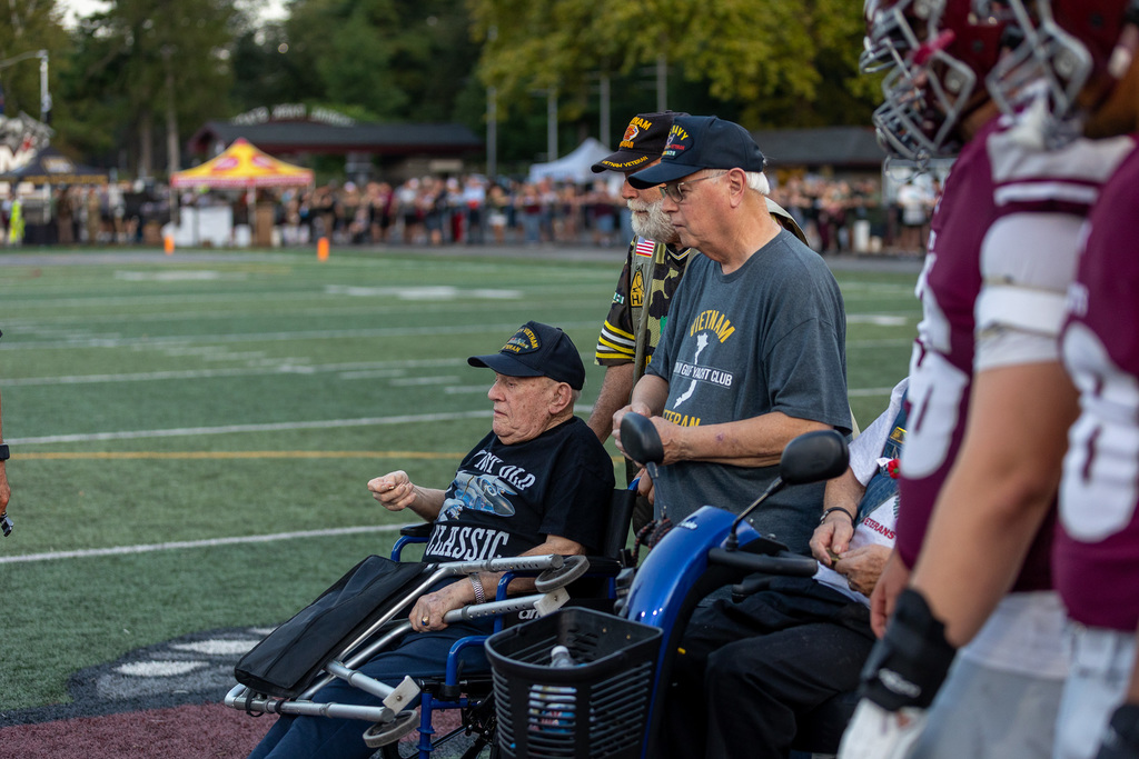 Veterans on a football field for a Salute to Service ceremony