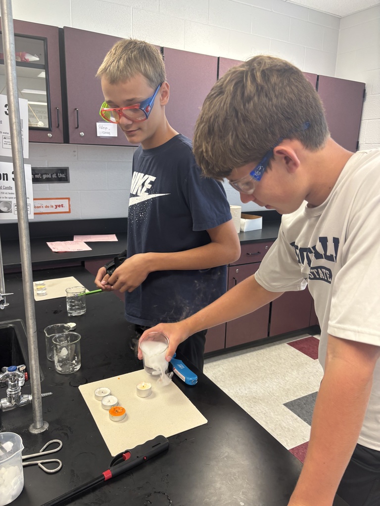 Students using dry ice in a middle school science lab.