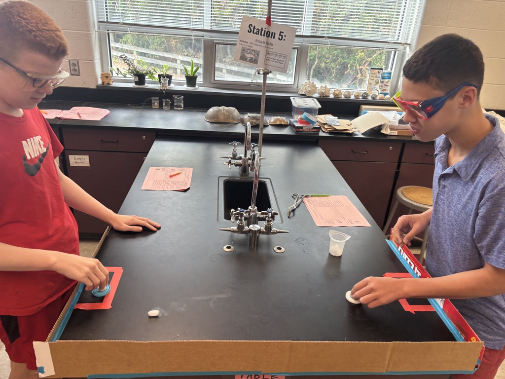 Students using dry ice in a middle school science lab.