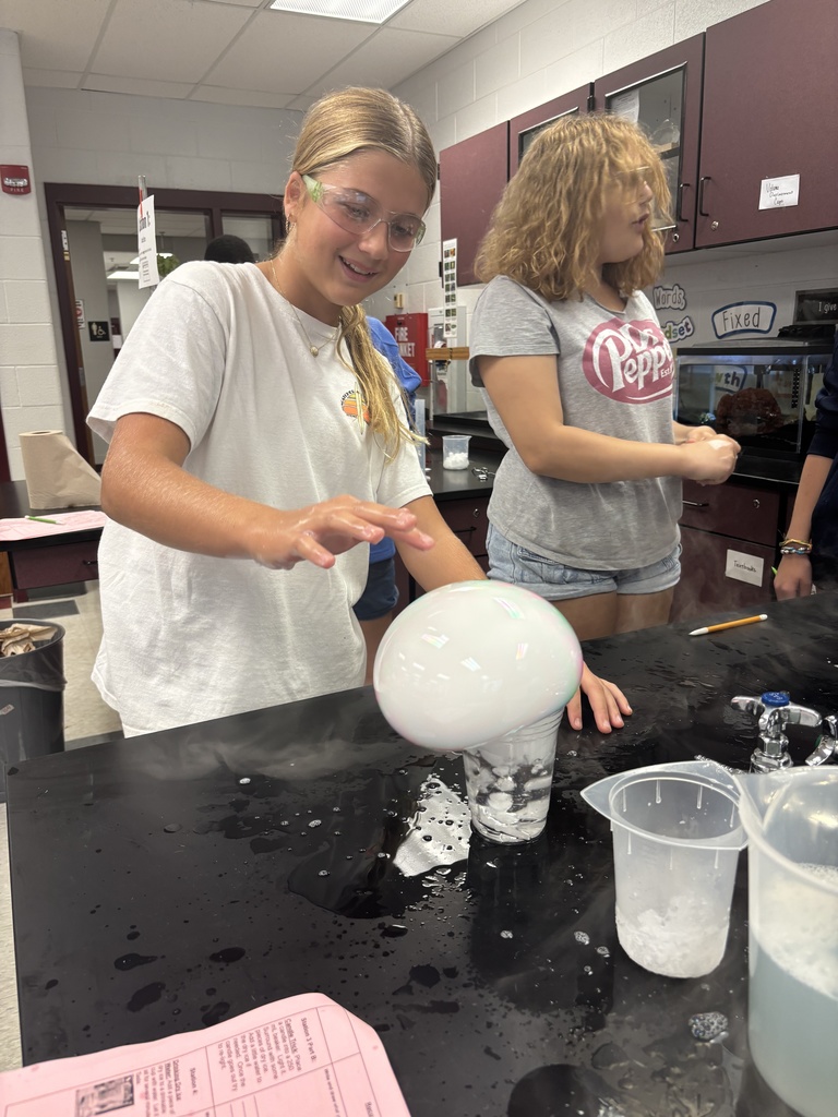 Students using dry ice in a middle school science lab.