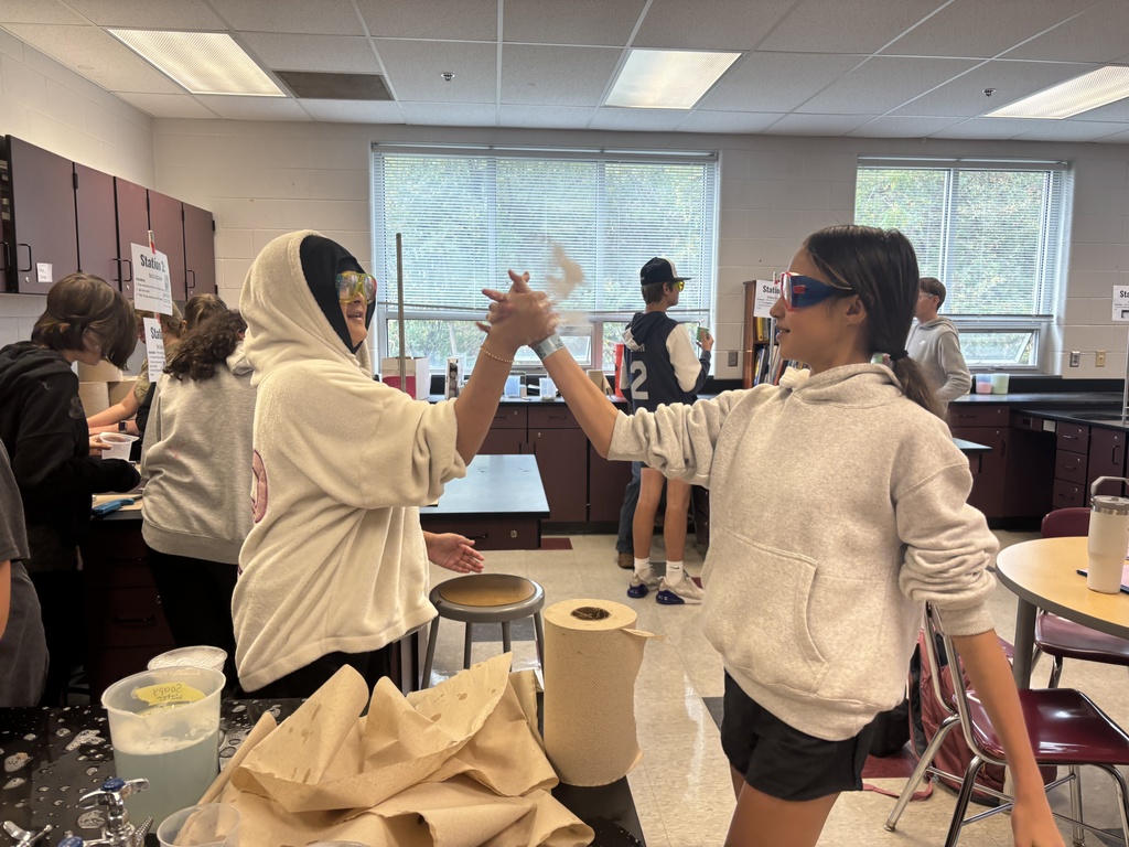 Students using dry ice in a middle school science lab.