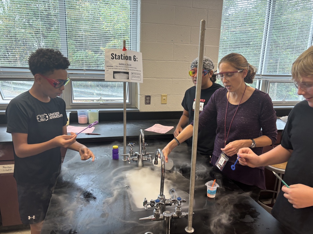 Students using dry ice in a middle school science lab.
