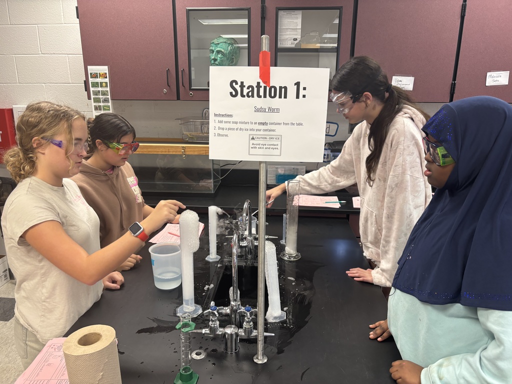 Students using dry ice in a middle school science lab.
