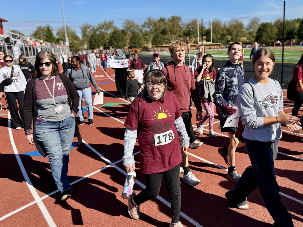 Special olympians and their buddies walk in the opening ceremonies.