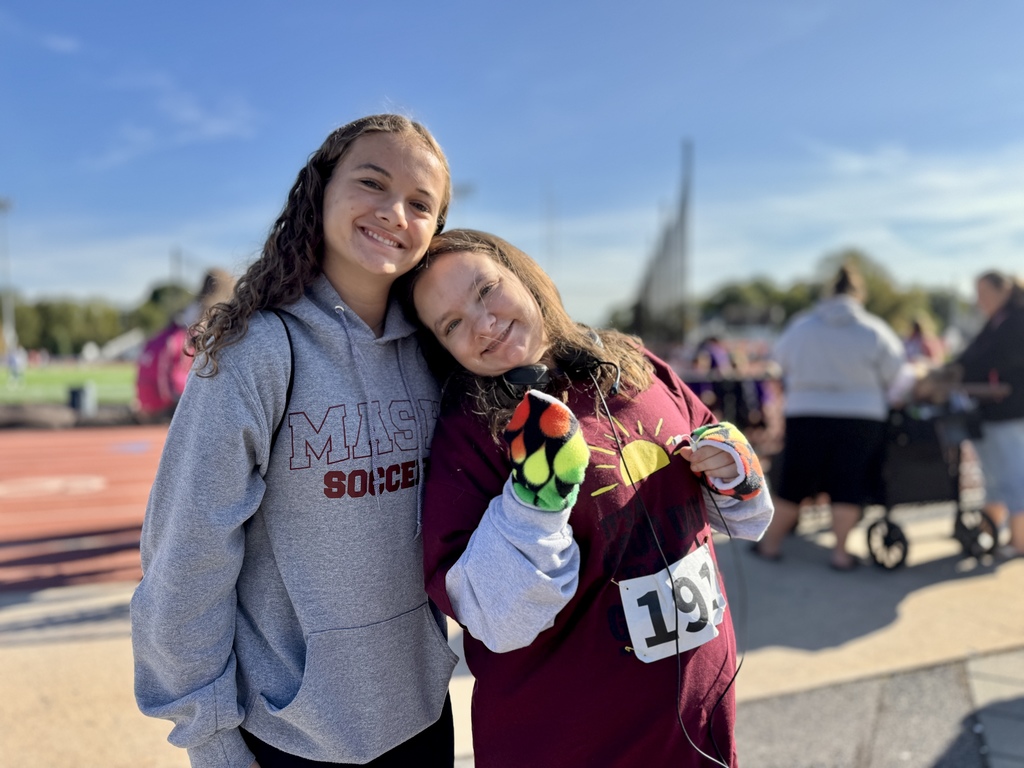 A special olympian and her big buddy.