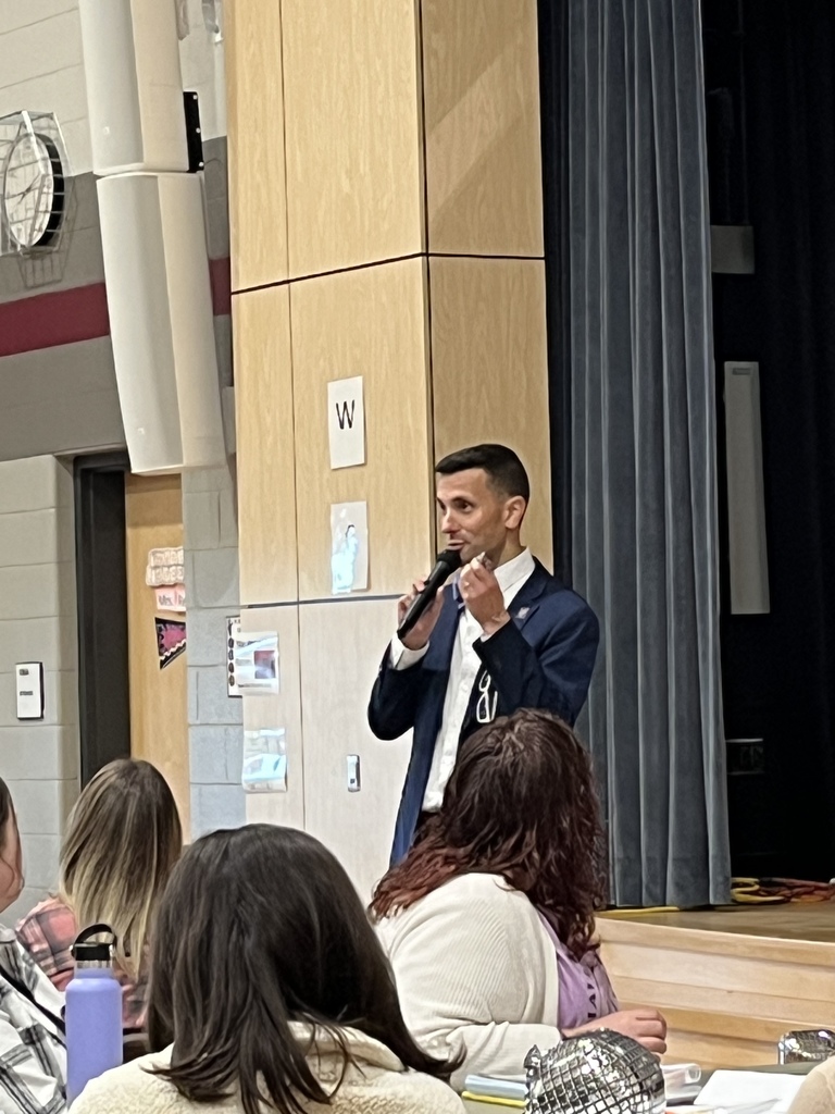 Superintendent speaks in front of a group of teachers.