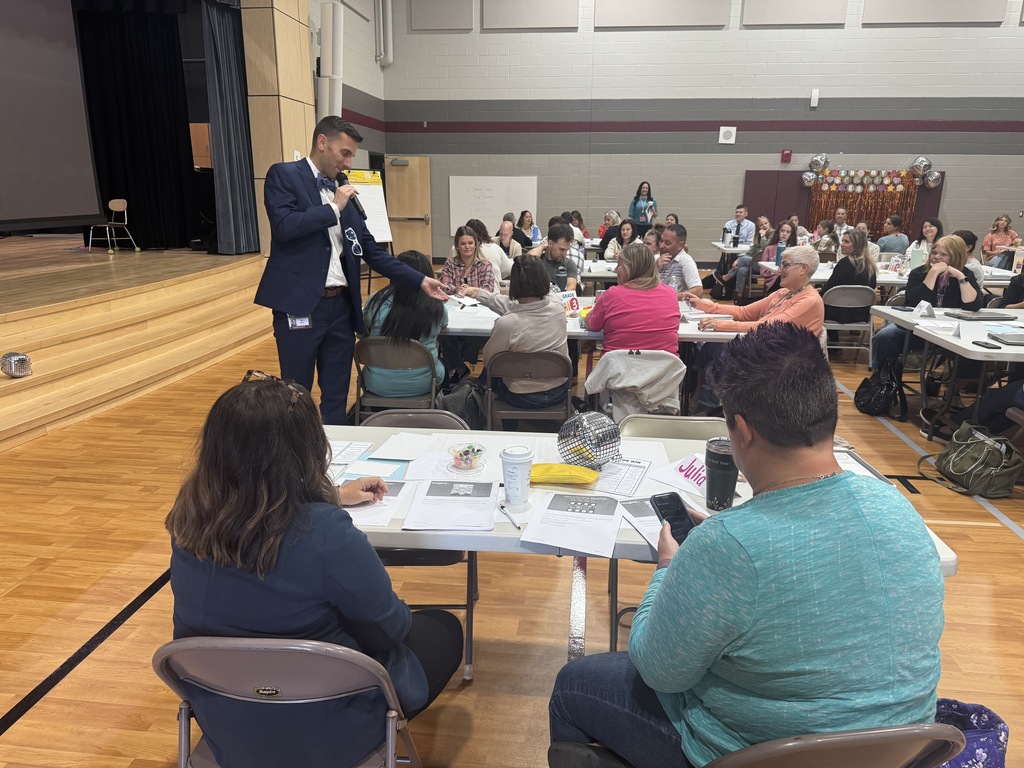 Superintendent speaks in front of a group of teachers.