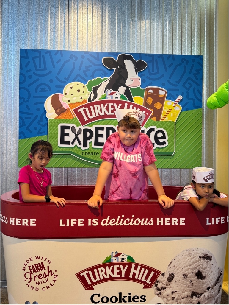 Students standing in a pretend ice cream container.