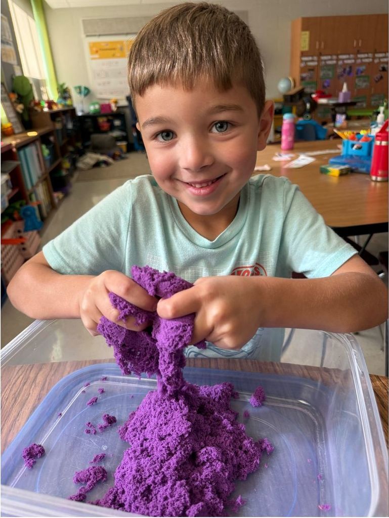 picture of a student playing with kinetic sand