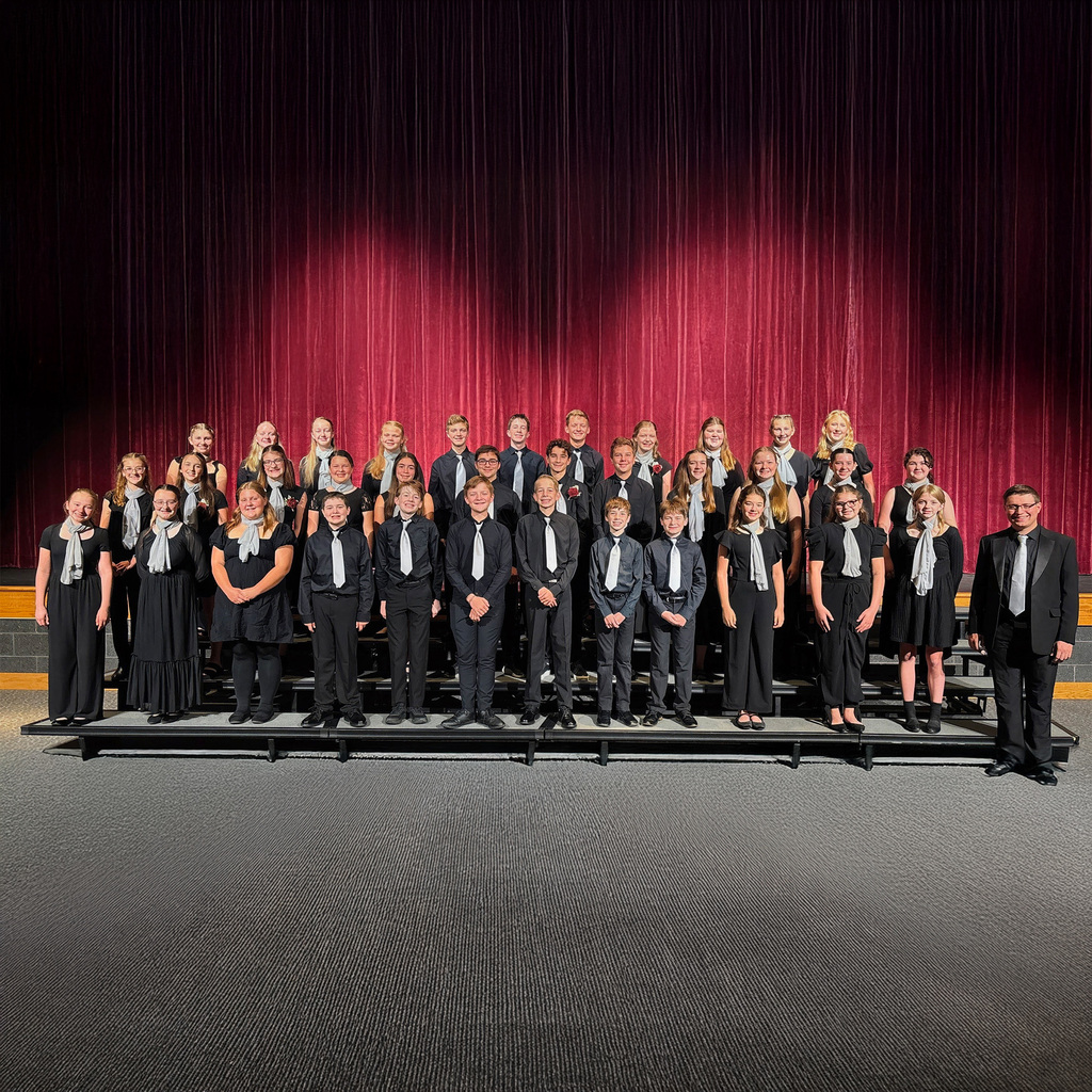 Group of singers standing on risers.