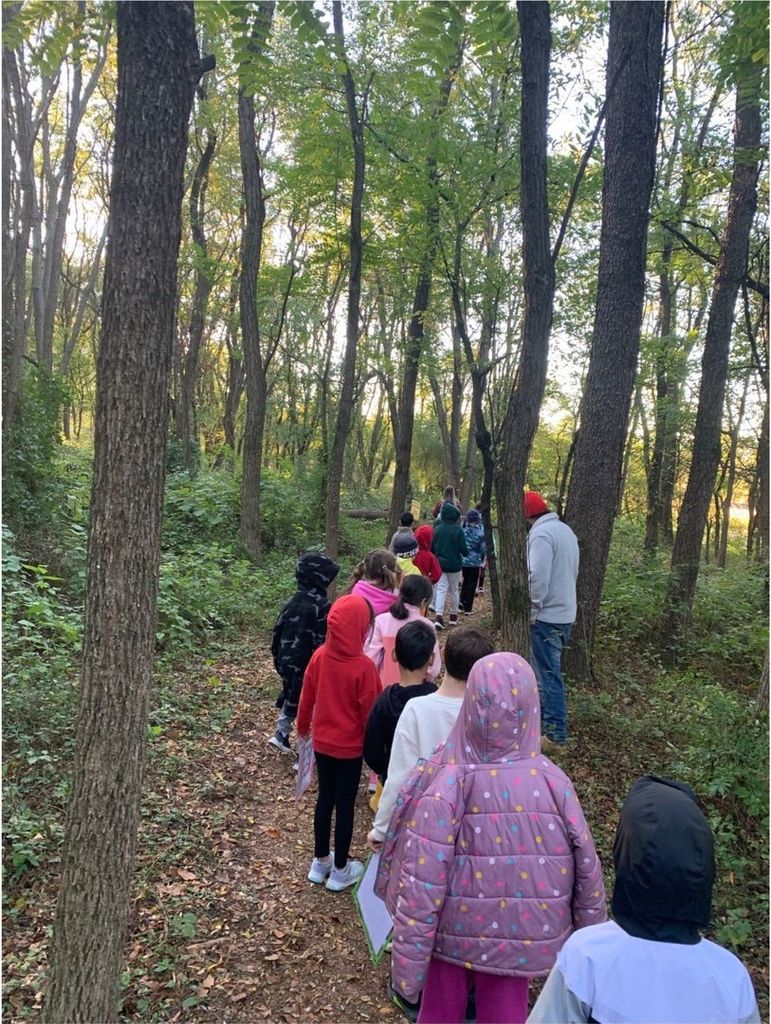 photograph of students walking on a trail