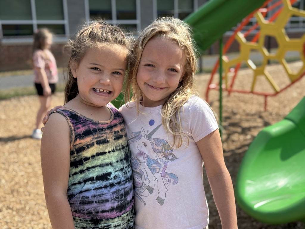 Two friends together on the playground.