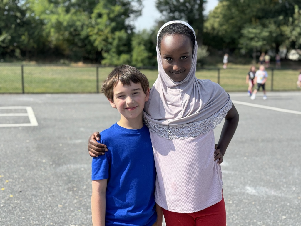 Two friends together on the playground.