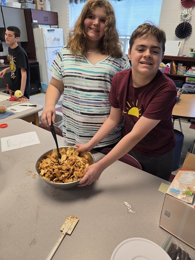 Students make apple crisp.