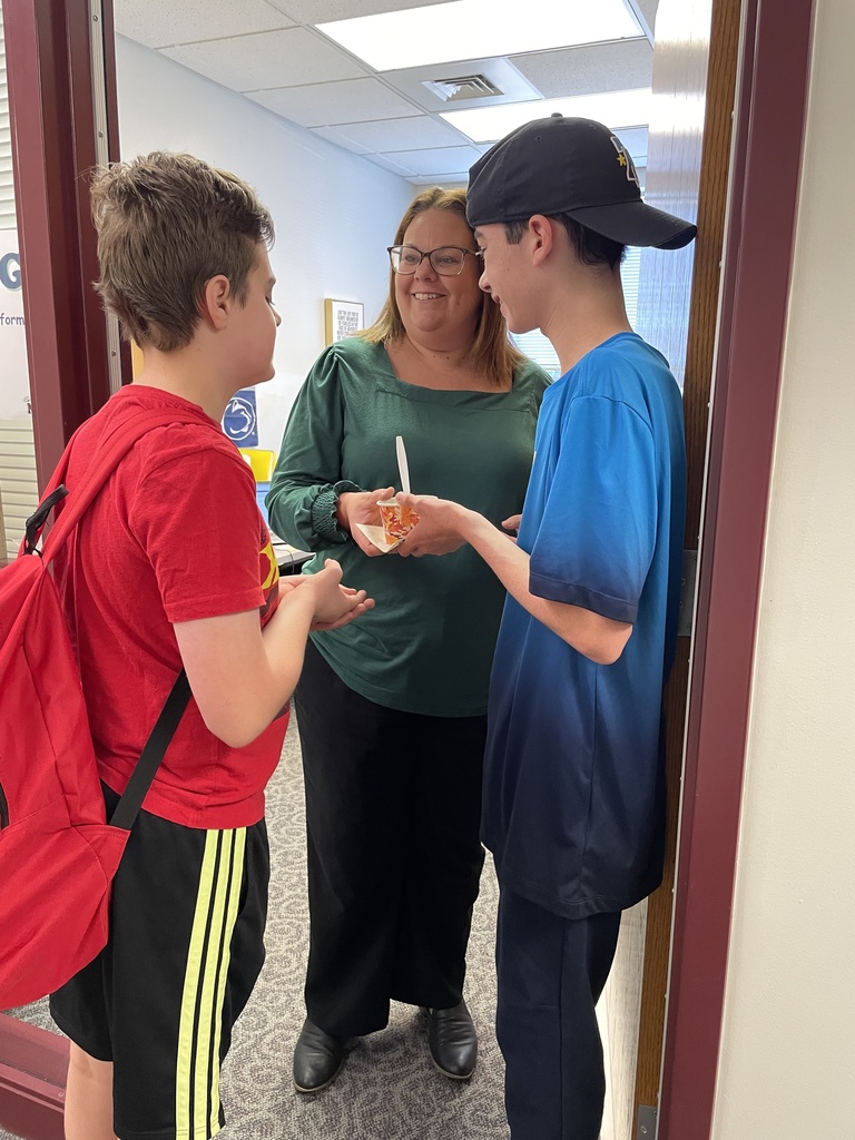 Students deliver fresh baked apple crisp to a staff member.