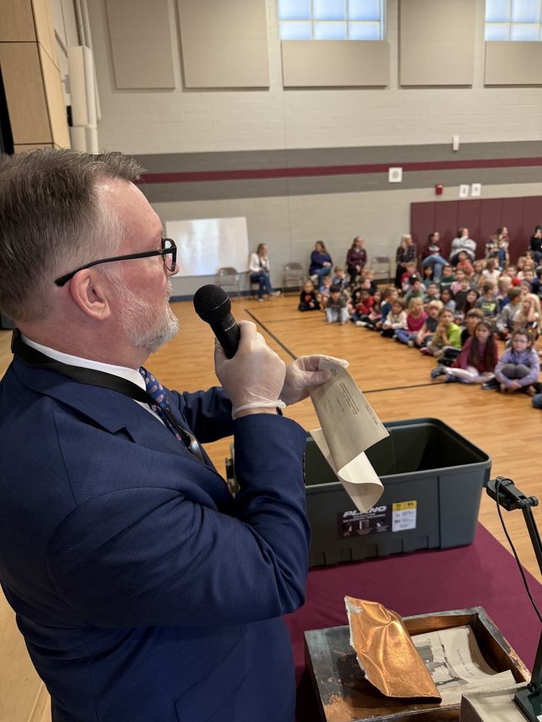 photo of mr mcintosh taking items out of the time capsule