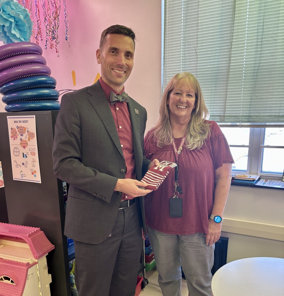 A man presenting a pair of branded socks to a staff member.