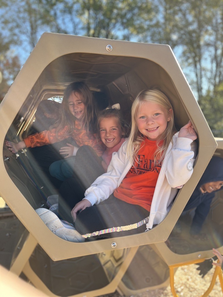 Students in orange on the playground.