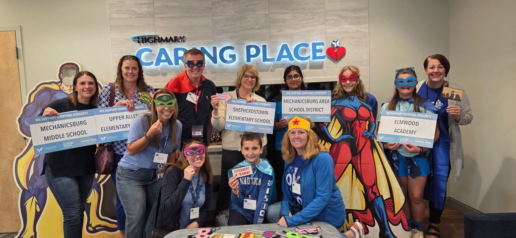 A group of students and staff dressed as superheroes.