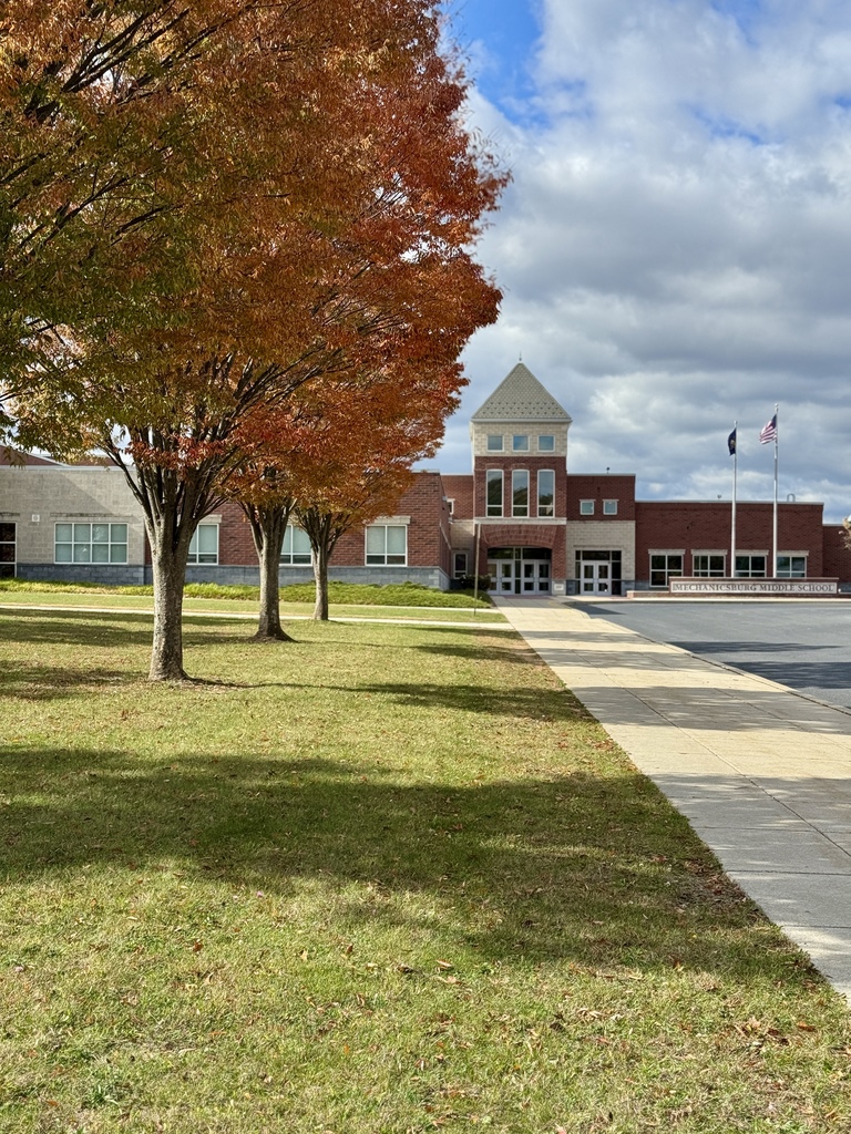 Colorful fall trees in front of a school.