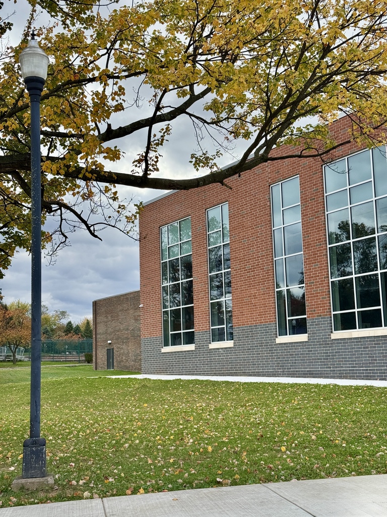 Colorful fall trees in front of a school.