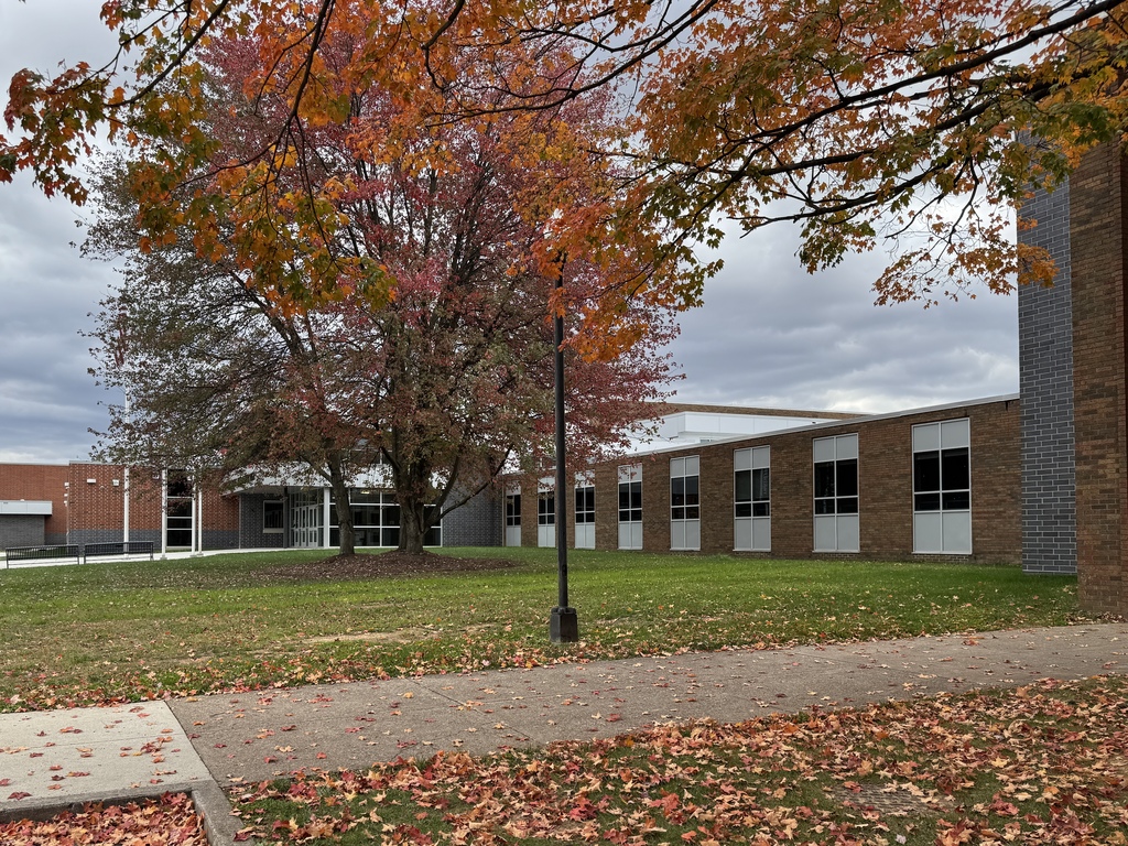Colorful fall trees in front of a school.