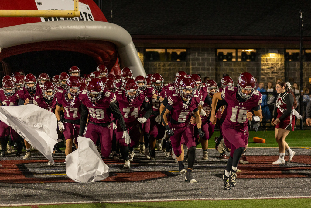 football players running onto the field
